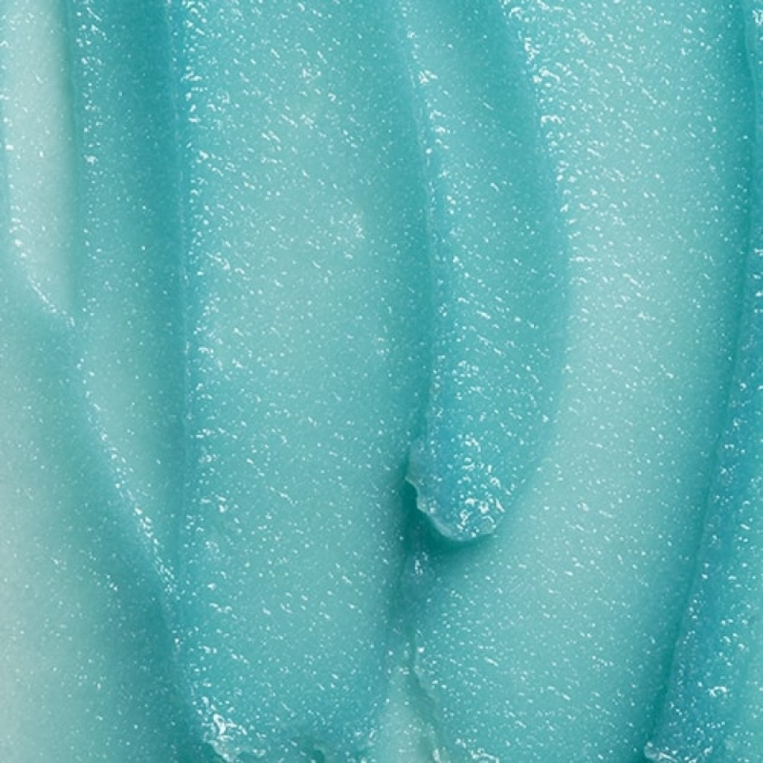 Close-up of blue exfoliating polish gel texture with visible granules for skincare