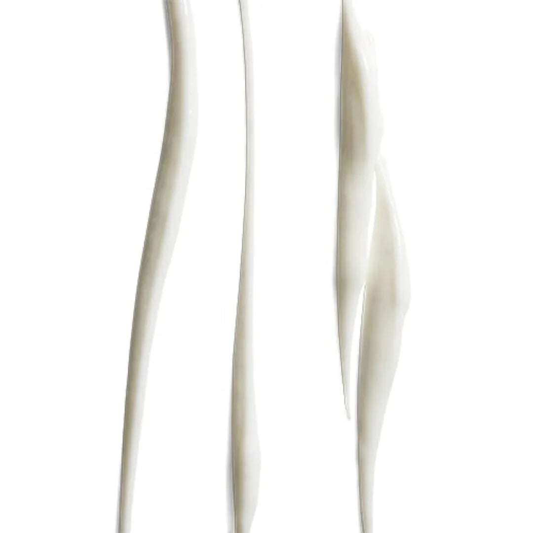 Close-up of smooth, white cosmetic cream streaks on a white background, representing skincare product texture