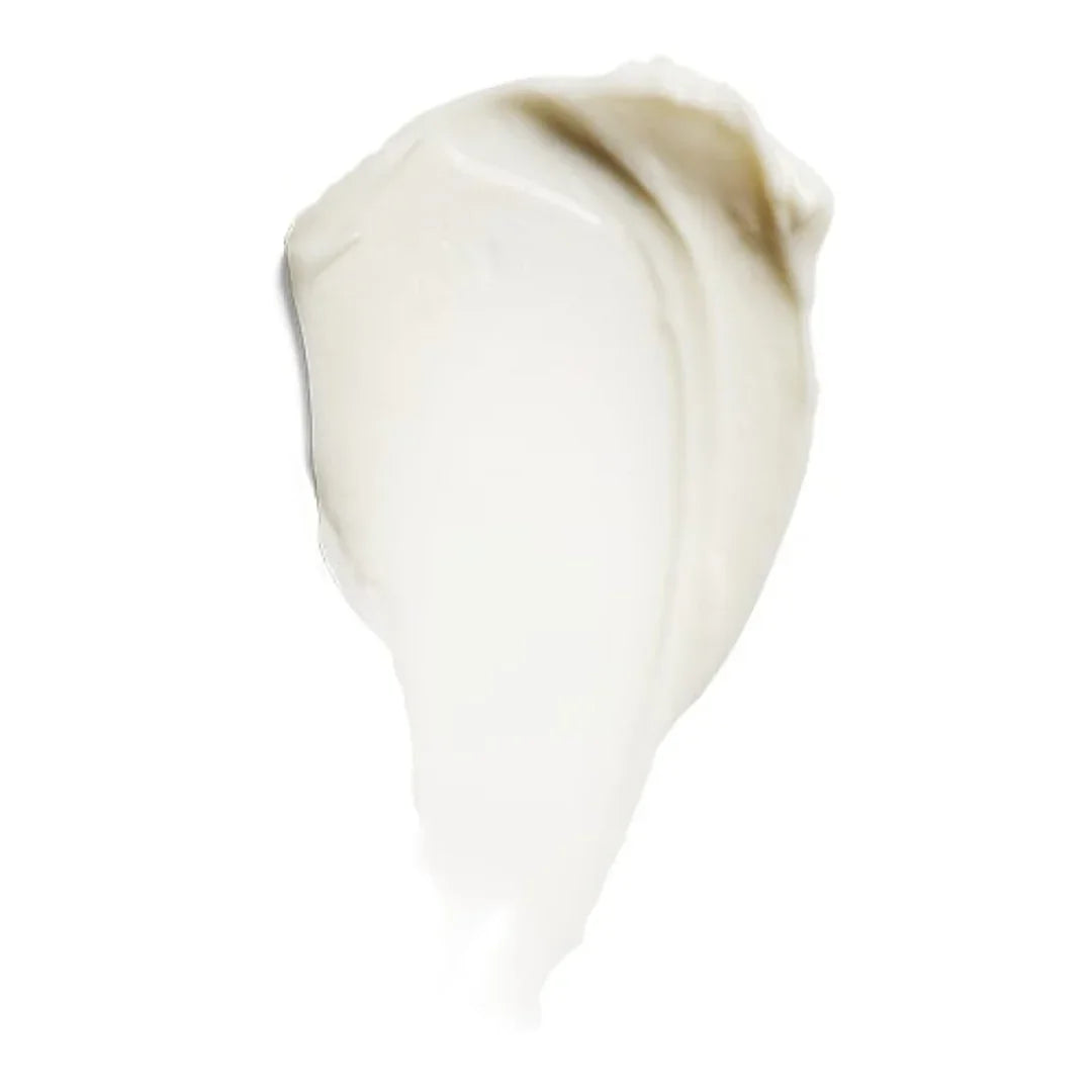 Close-up of creamy white eye cream texture on white background
