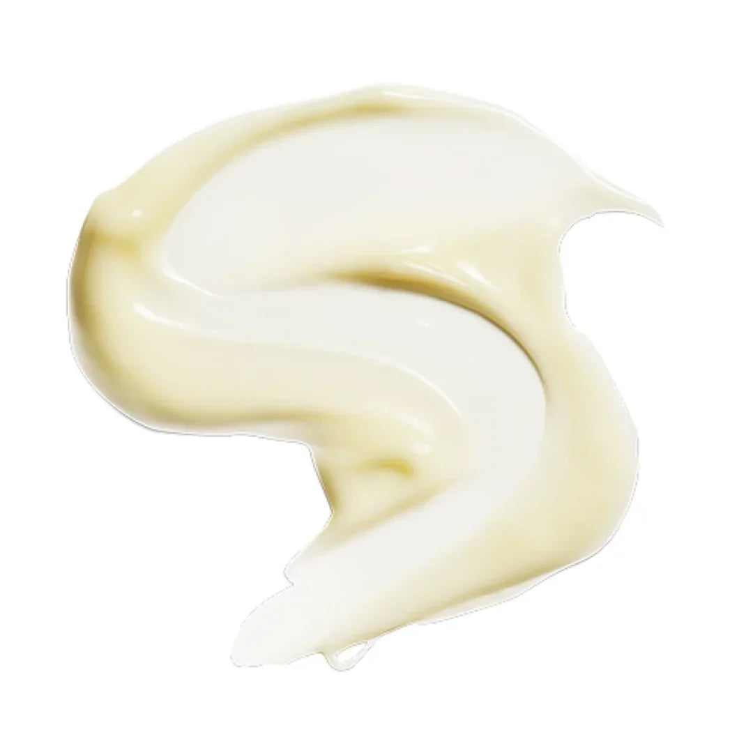 Close-up of creamy beige and white skin brightener cream texture on white background