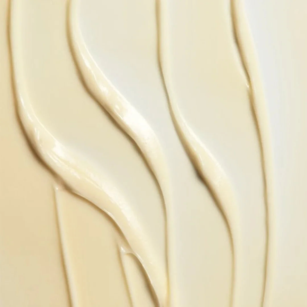 Close-up of smooth beige and cream body emulsion cream swatches with glossy texture
