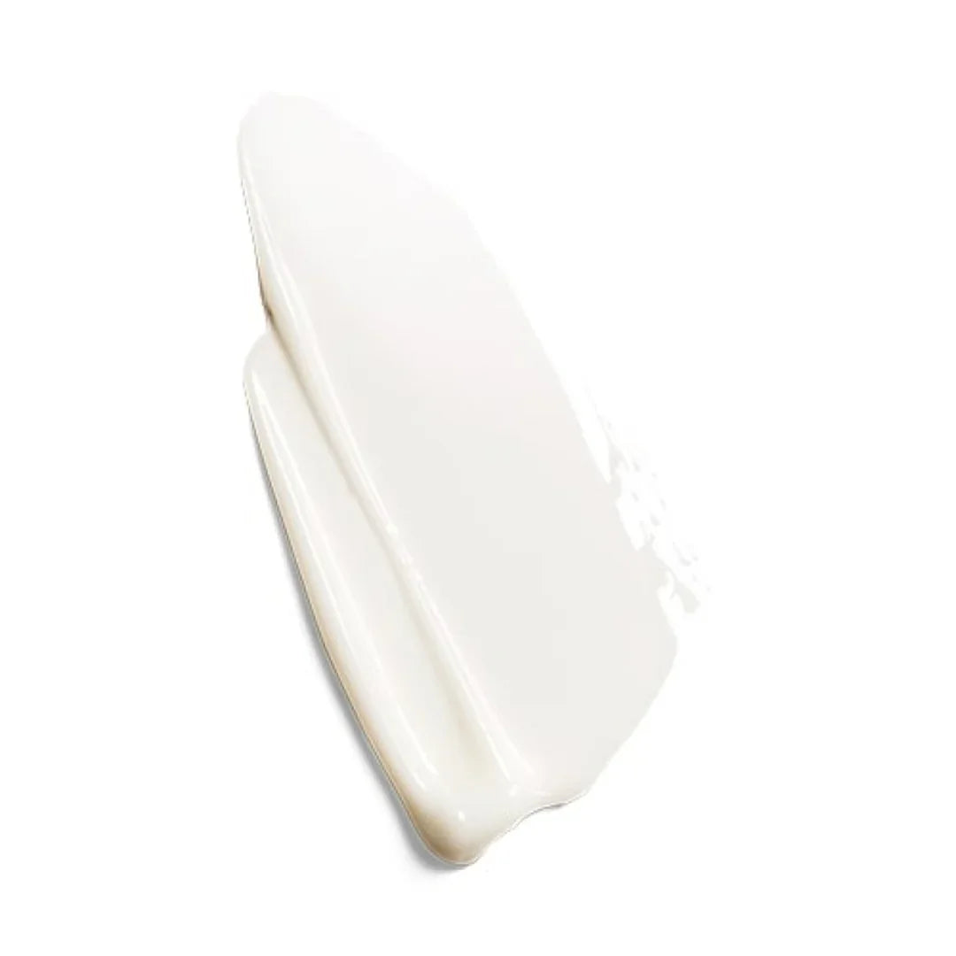 Close-up of smooth white skincare cream swatch on white background