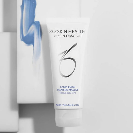 ZO Skin Health Complexion Clearing Masque tube on white surface with blue cosmetic cream smear