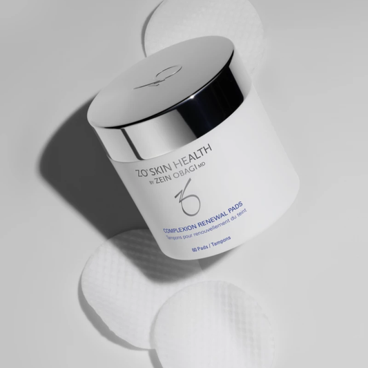 Container of Zo Skin Health Complexion Renewal Pads with silver lid and cotton pads on white background