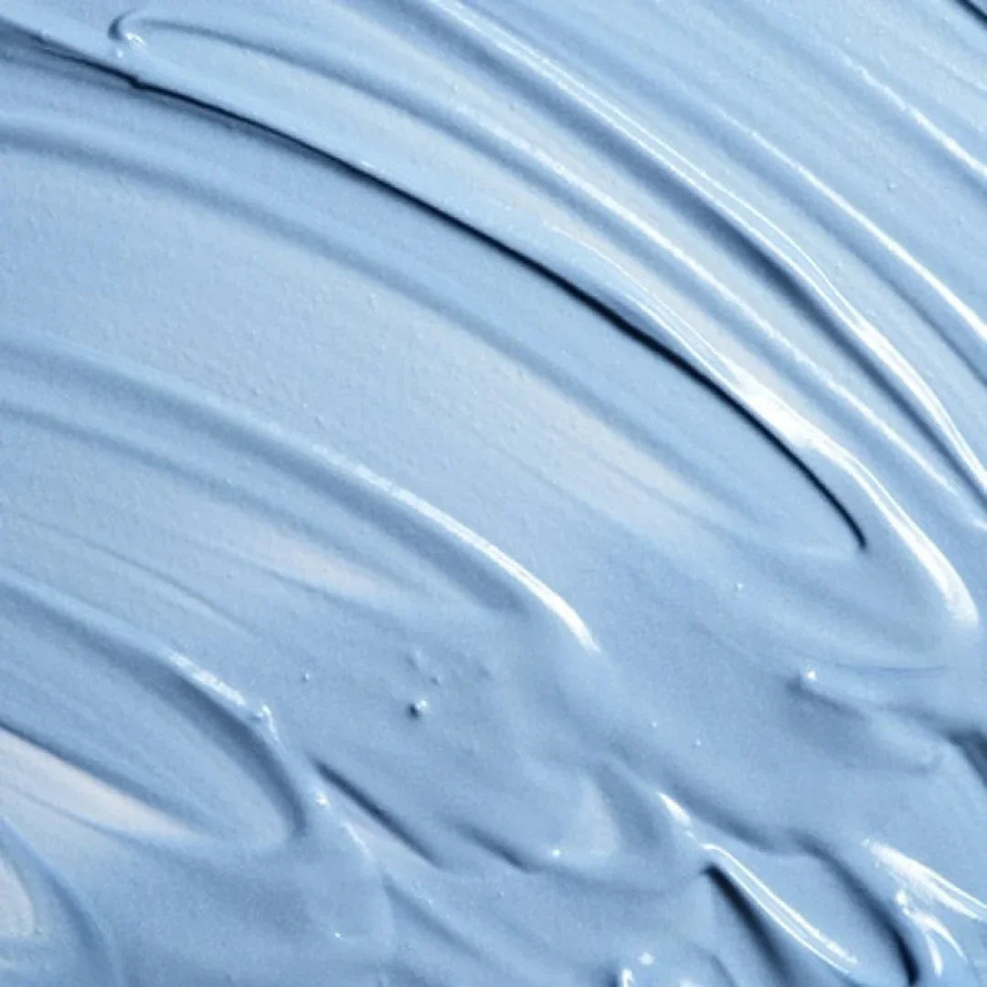 Close-up of smooth, creamy light blue complexion clearing face masque texture
