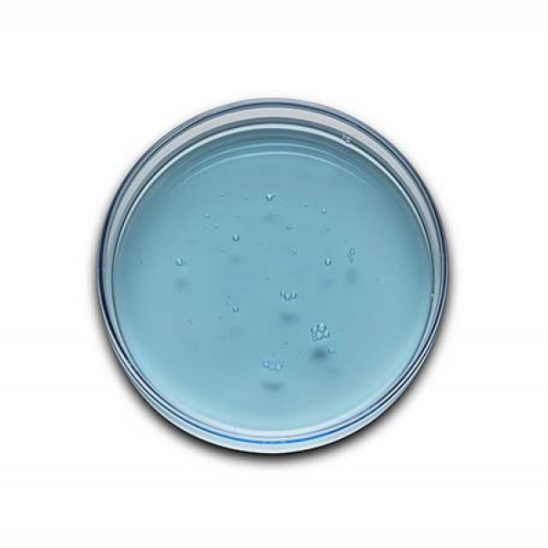 Top view of light blue skincare gel with bubbles in a clear round container on white background