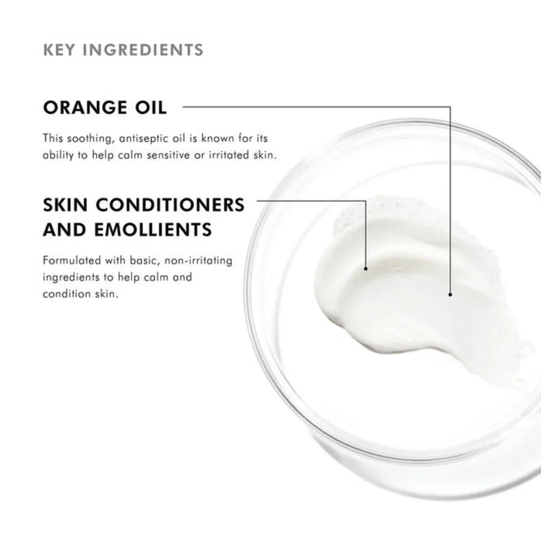 Close-up of white cream in a clear bowl with text highlighting orange oil and skin conditioners as key soothing skincare ingredients