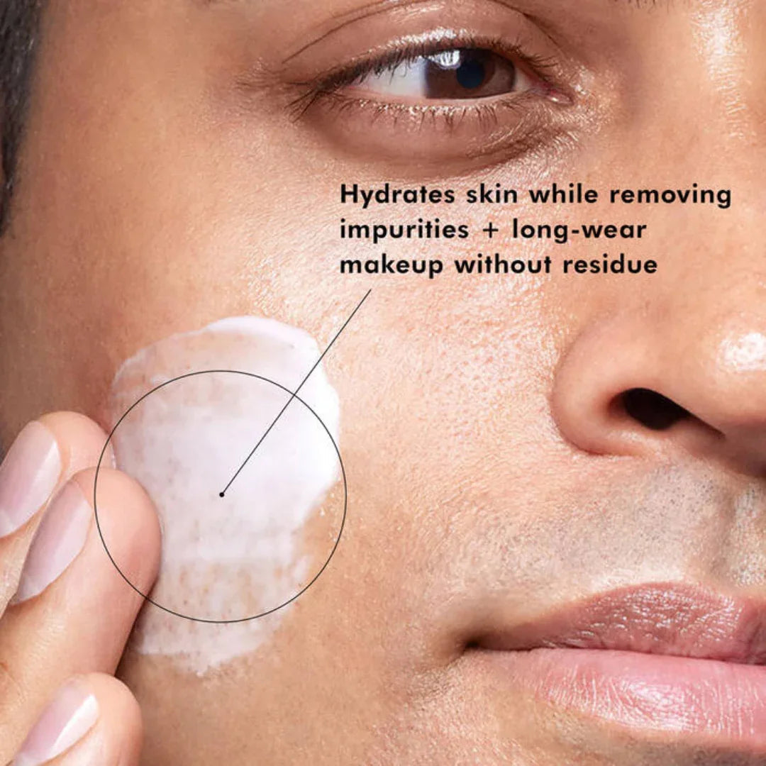 Close-up of person applying gentle cream cleanser on cheek with hydrating and makeup-removing benefits
