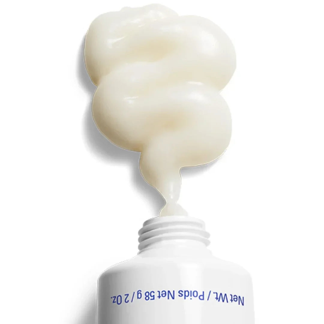 Close-up of thick white hydrating creme squeezed from a white tube with blue text