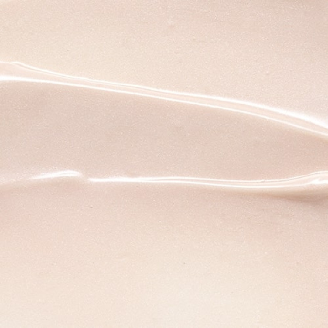 Close-up of smooth, glossy beige serum texture with light reflections on surface
