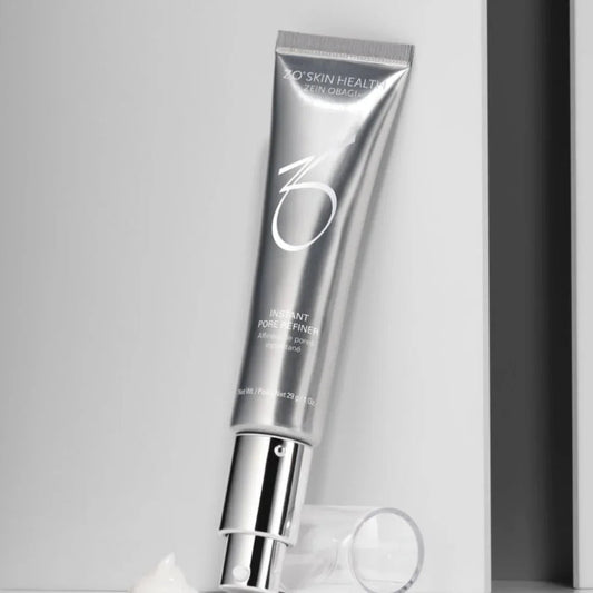 Silver tube of ZO Skin Health Instant Pore Refiner with pump and cream on white surface
