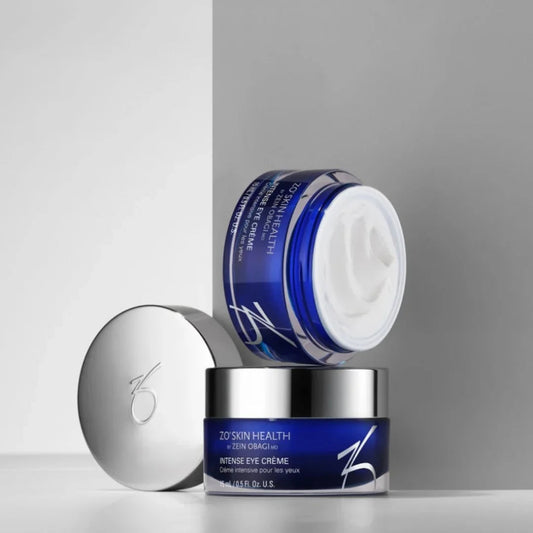 ZO Skin Health intense eye crème in blue jar with silver lid on white and gray background