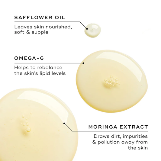 Cleansing oil drops with labels for safflower oil, omega-6, and moringa extract benefits