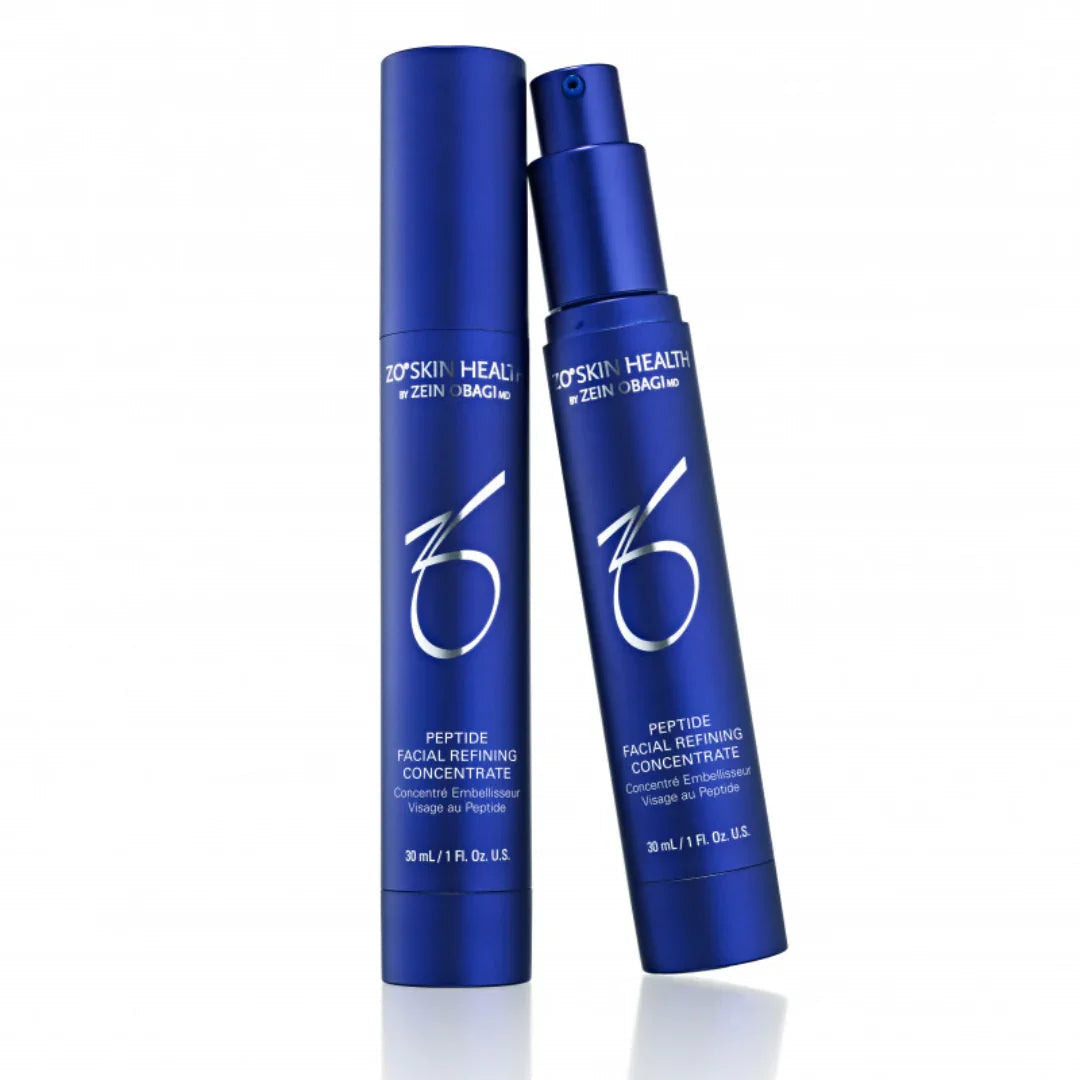Blue bottles of ZO Skin Health Peptide Facial Refining Concentrate skincare product on white background