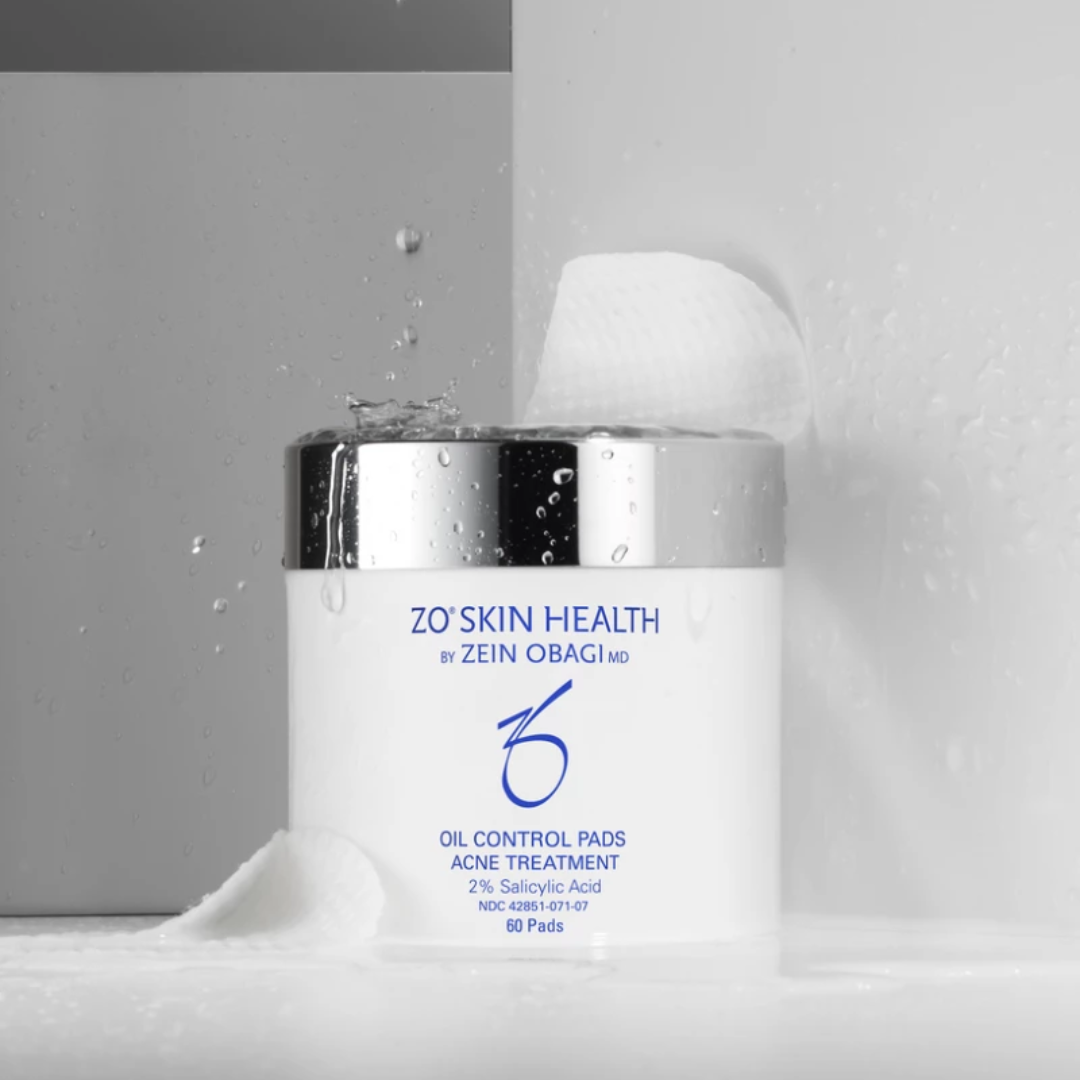 ZO Skin Health Oil Control Pads acne treatment container with water droplets and a pad